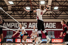 The IU Southeast women's volleyball team completes a play at the net.